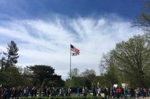 Marchers pass by the flagpole on Illinois State's Quad during the March for Science in Normal. (Photo by Megan Kathol Bersett)