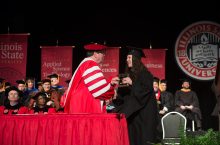 Emily Vigneri accepts the Civil Service Distinguished Service Award from President Larry Dietz at this year's Founders Day Convocation.